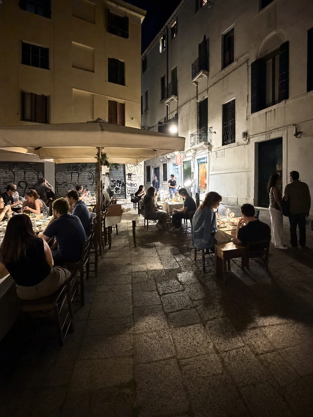 Couples dining in the evening at the taverna's outdoor tables